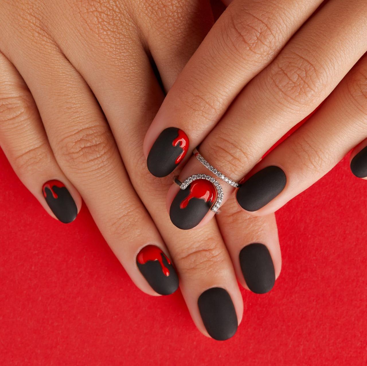 manicured female hands with fashion accessories trendy autumn halloween bloody spooky nail design