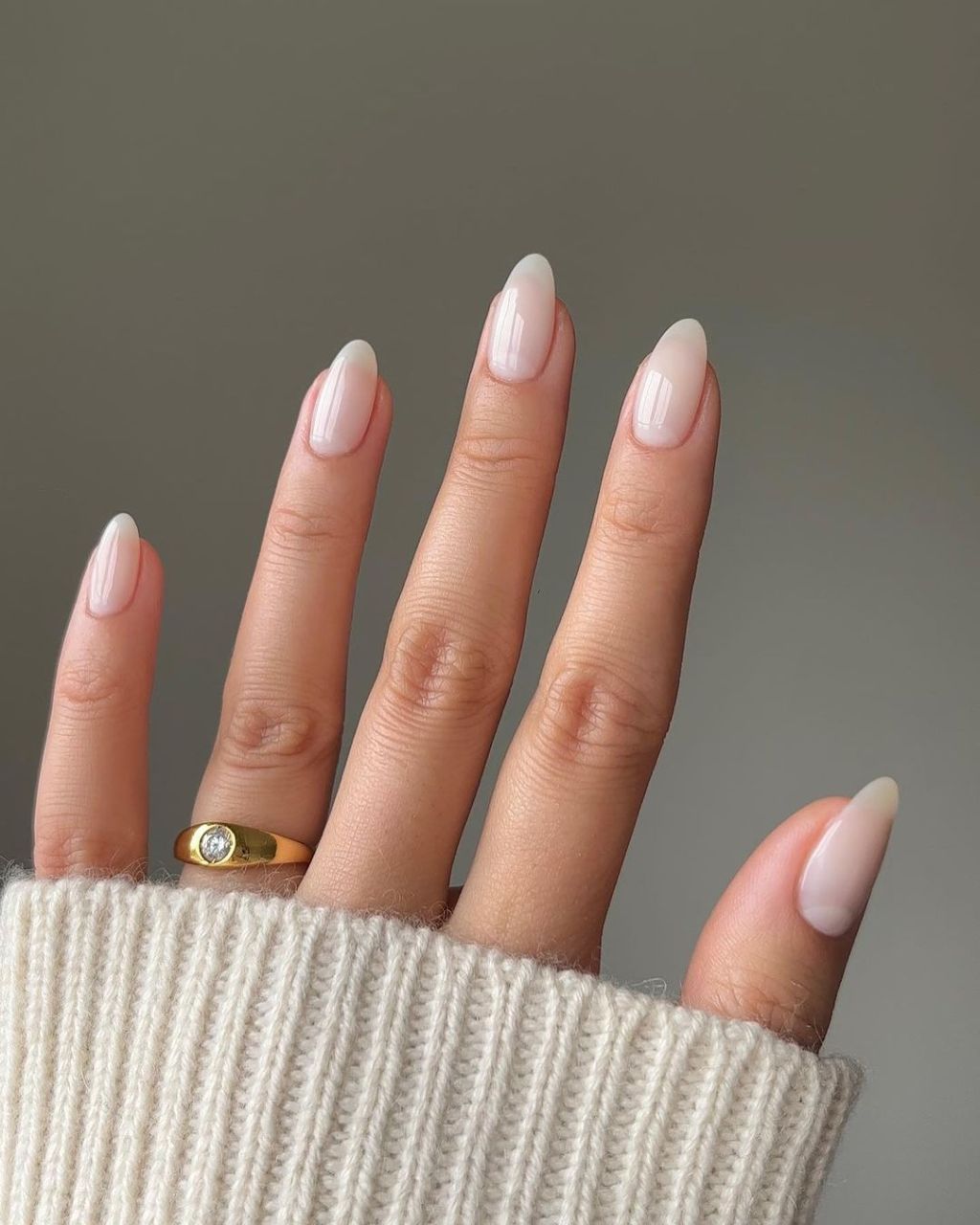 simple almond shaped milky nails with a white polish color