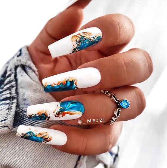 unique white coffin with ocean effect blue marble nail design ideas