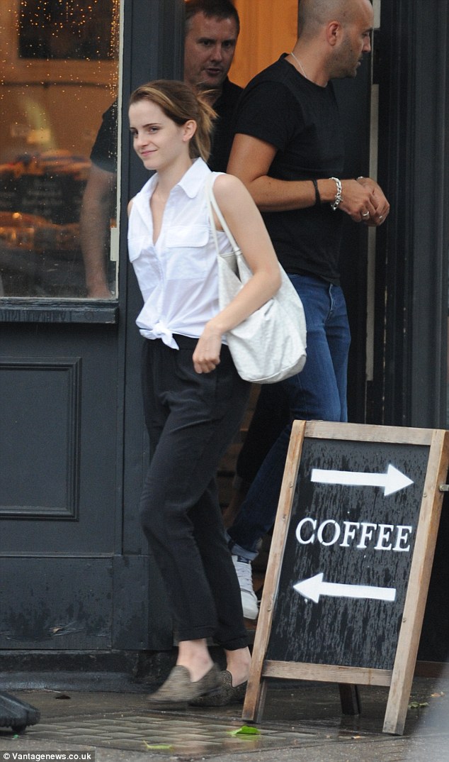 Effortlessly elegant: Emma Watson meets a friend for a coffee in central London wearing a tie top and black slacks