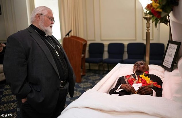 Reverend Robert Whitmer visits 'Stoneman Willie' during his funeral service in Reading, Pennsylvania, on October 7, 2023