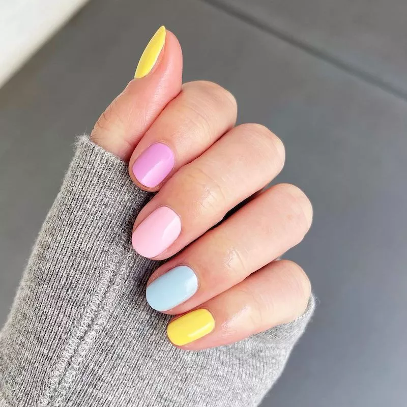 Mismatched pastel polish on short nails