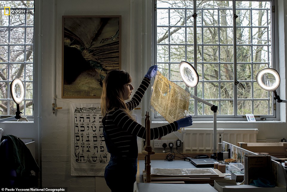 Cambridge University Library conservator Emma Nichols examines a Hebrew text. the centre  houses 200,000 Jewish manuscripts