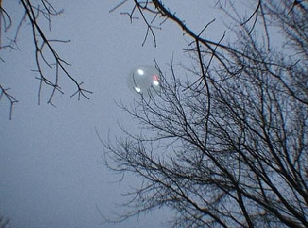 The civilian UFO group UFO Wisconsin reported receiving two 'low-end digital camera' snaps of an apparently saucer-shaped craft, taken by a mother who had been pH๏τographing her son sledding in the town of Weyauwega, an approximately one-hour drive west from Green Bay