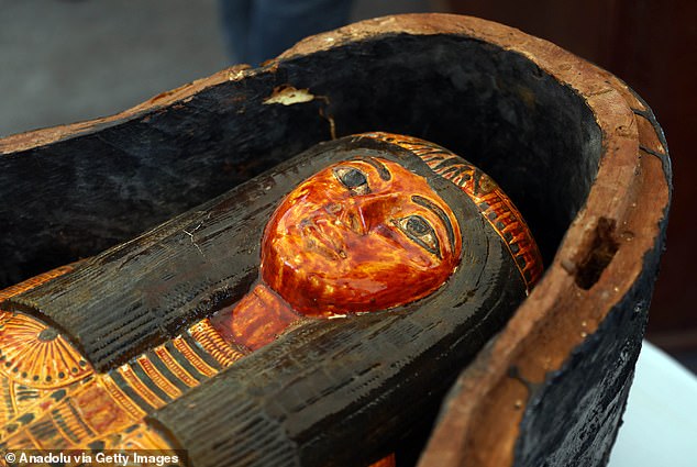 Colourful: The cemetery includes wooden coffins inscribed with the names of two women