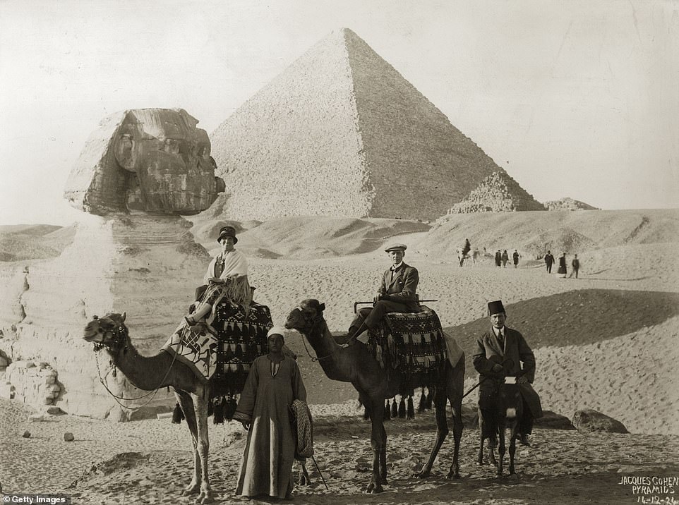 A gallery of black and white snaps selected by DailyMail.com reveal what Egypt looked like before tourism had taken hold. Pictured, a couple pose for a pH๏τo during a camel trip to see the Sphinx and pyramids in 1924