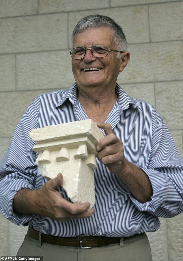 Ehud Netzer holds a pieces of an elaborate sarcophagus believed to have contained King Herod's remains