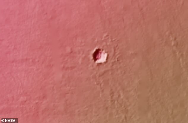 Scientists are unsure how deep the holes on Mars go (pictured). They believe they formed during after a volcanic explosion caused lava tubes to form