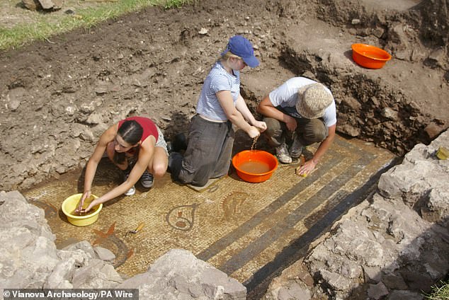 Pictured, archaeologists cleaning the amazing mosaic, which would have been commissioned by 'a wealthy and important person' in the Roman settlement