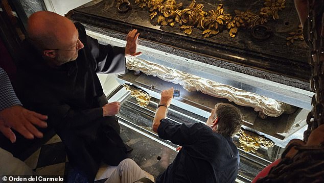 Saint Teresa's remains were moved to a locked room where experts can analyze her DNA and understand how to better preserve relics in the future. Pictured: The silver coffin encased in marble of Saint Teresa of Avila