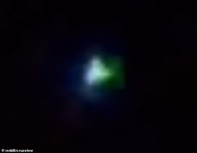 The video shows a small orb in the sky rapidly changing colors in the sky