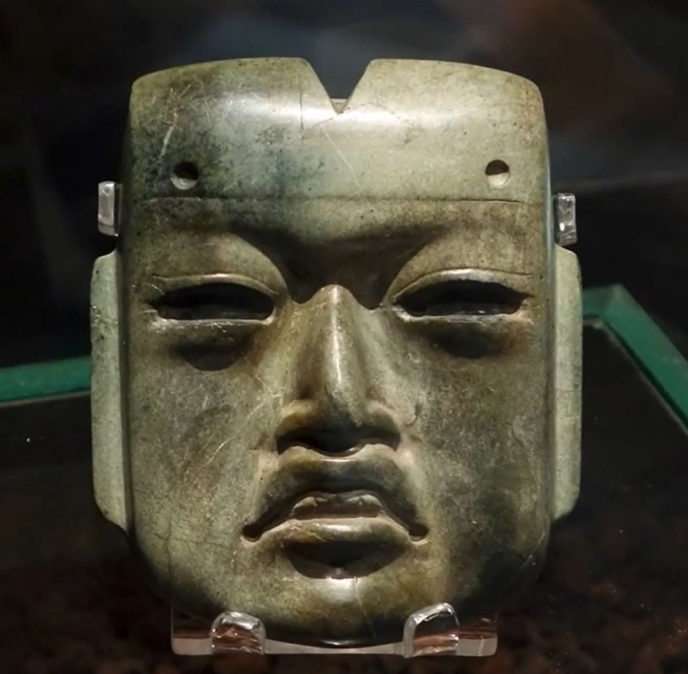 A separate Olmec mask the size of a human hand discovered in a burial site