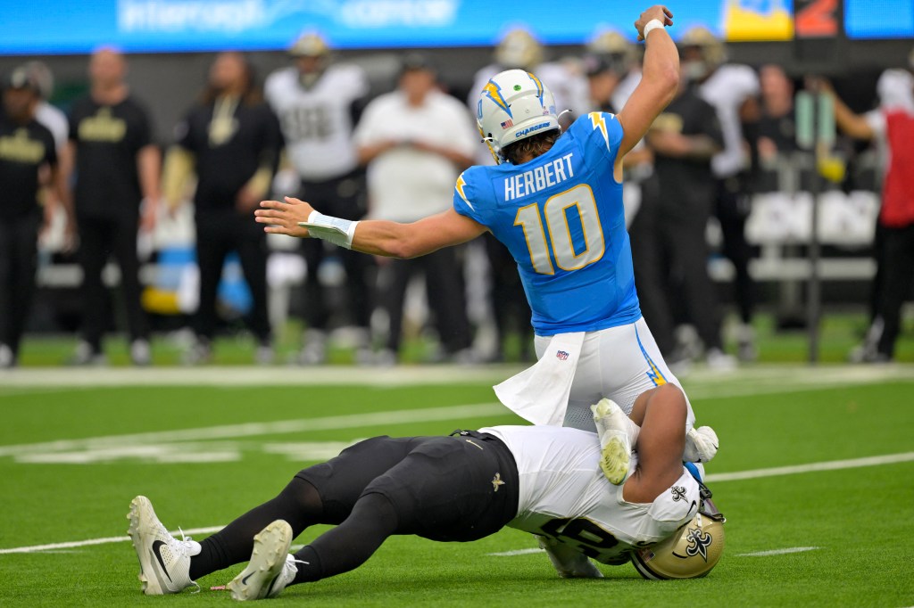 Chargers quarterback Justin Herbert (10) is sacked by New Orleans Saints defensive tackle Nathan Shepherd (93) on Oct. 27, 2024.