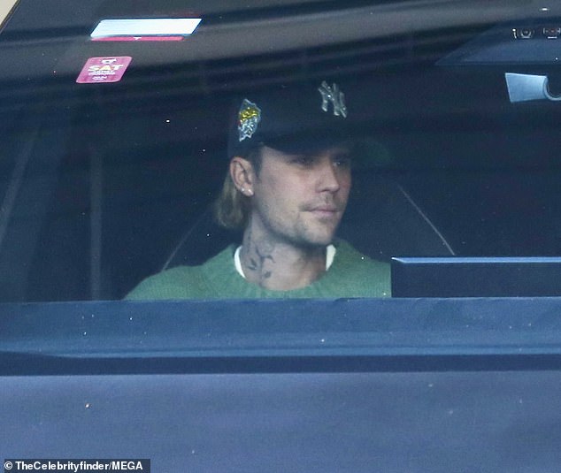 Justin Bieber, 30, appeared to show strain alongside wife Hailey, 27, as they drove their Cybertruck in Beverly Hills on Monday