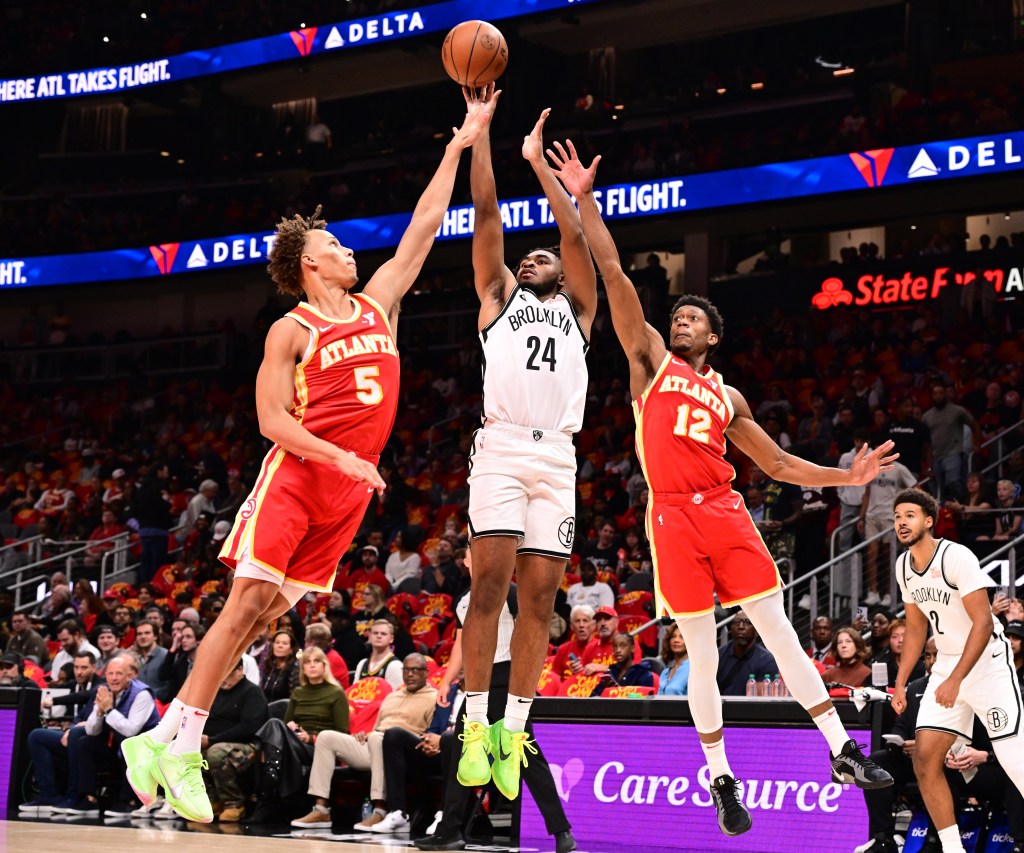 Onyeka Okongwu, who scored xx points, blocks Dorian Finney-Smith's sH๏τ during the Nets' 120-116 opening-night loss to the Hawks on Oct. 23, 2024.