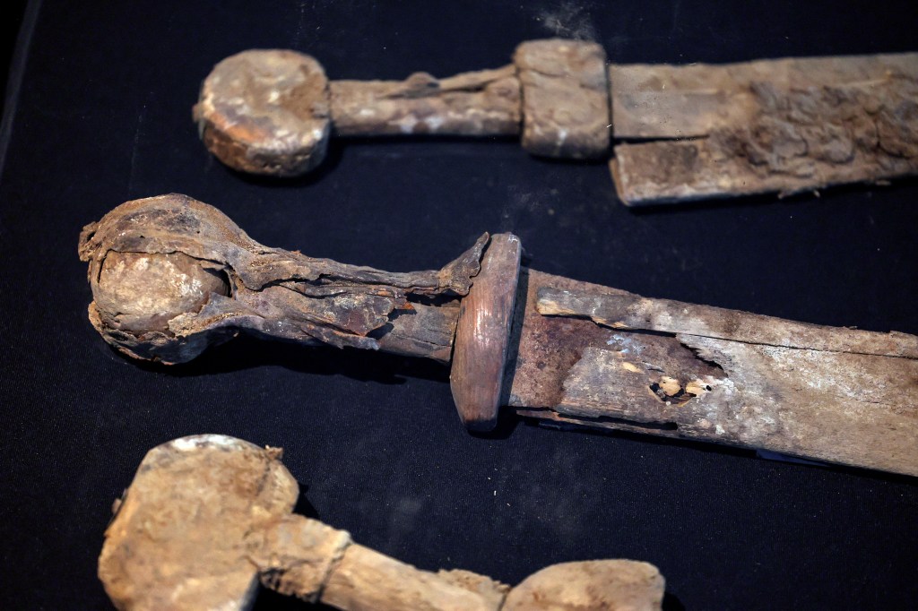 The weapons seen with their wooden and leather hilts and scabbards still intact 