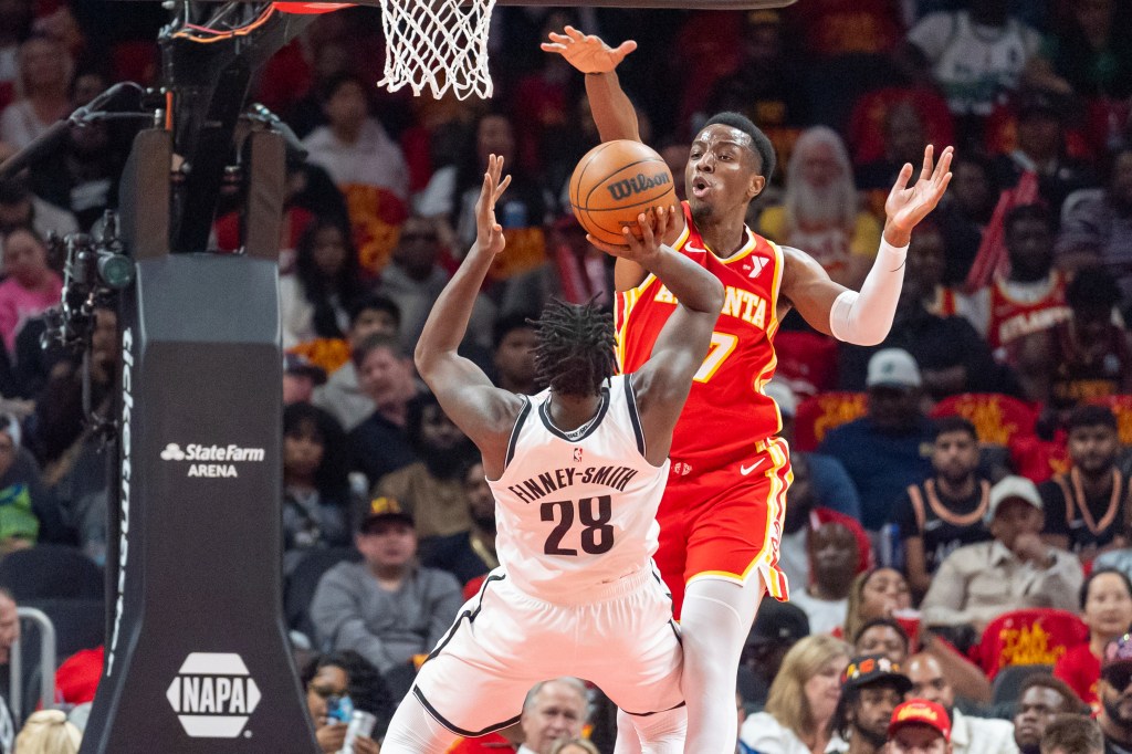 Onyeka Okongwu, who scored xx points, blocks Dorian Finney-Smith's sH๏τ during the Nets' 120-116 opening-night loss to the Hawks on Oct. 23, 2024.