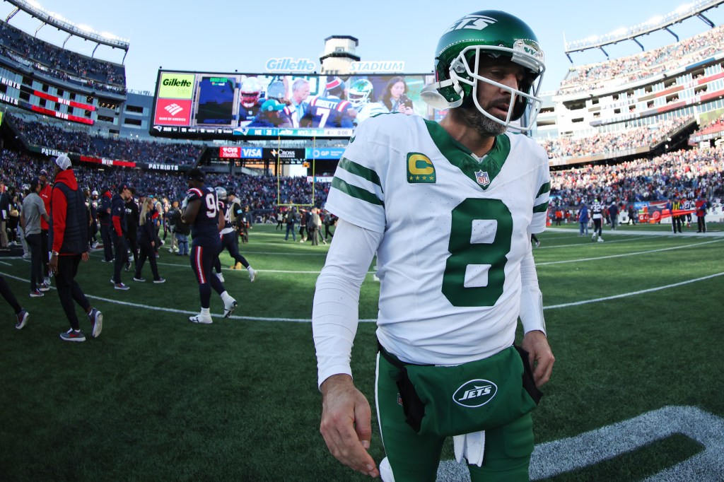 Aaron Rodgers exits the field after the Jets' 25-22 loss to the Patriots in New England on Oct. 27, 2024.