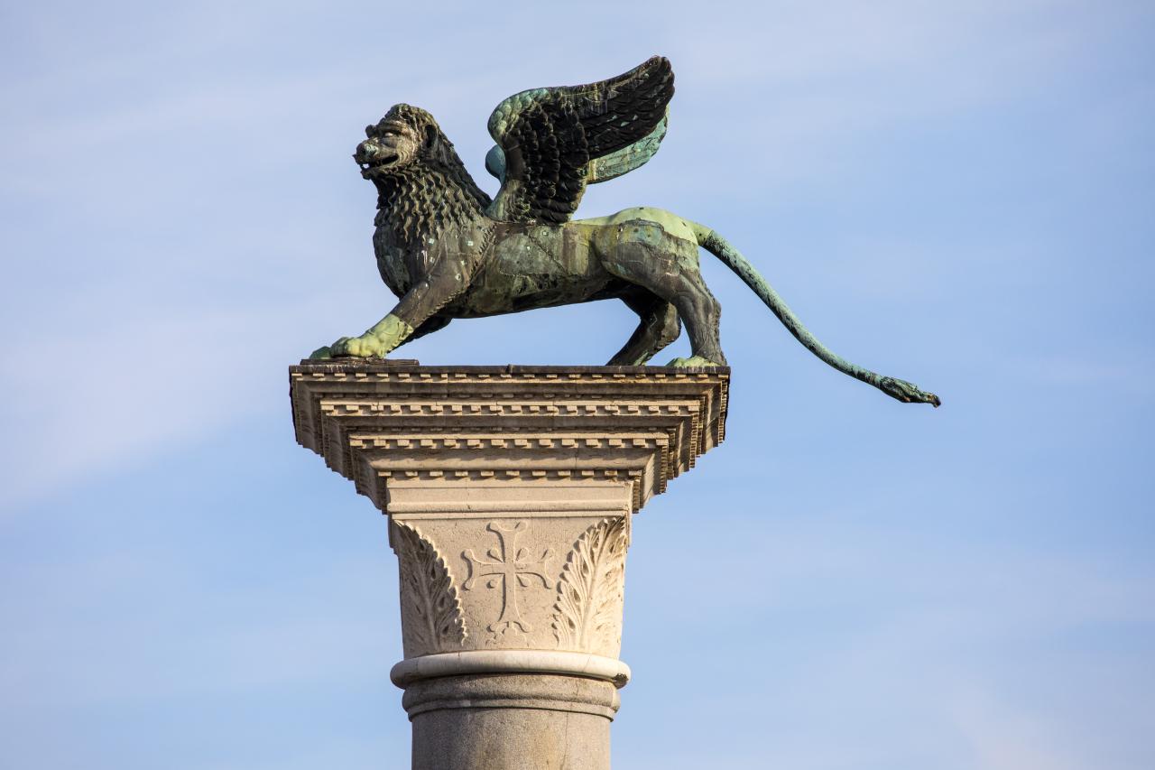 The famed Lion of Venice sits high upon a pillar in St Marks Square