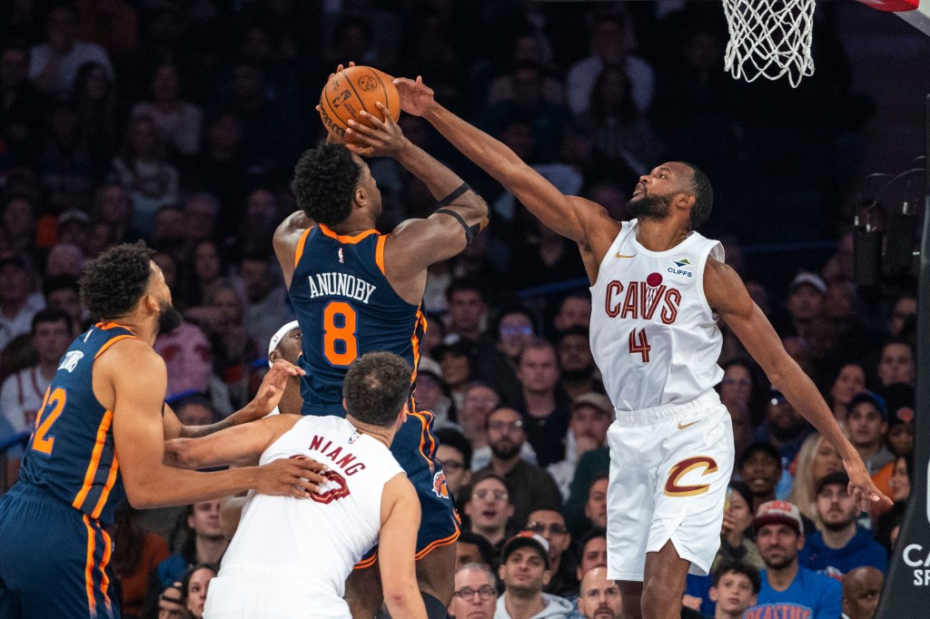 Knicks forward OG Anunoby (8) is defended by Cleveland Cavaliers forward Evan Mobley (4) during the first half at Madison Square Garden, Monday, Oct. 28, 2024,