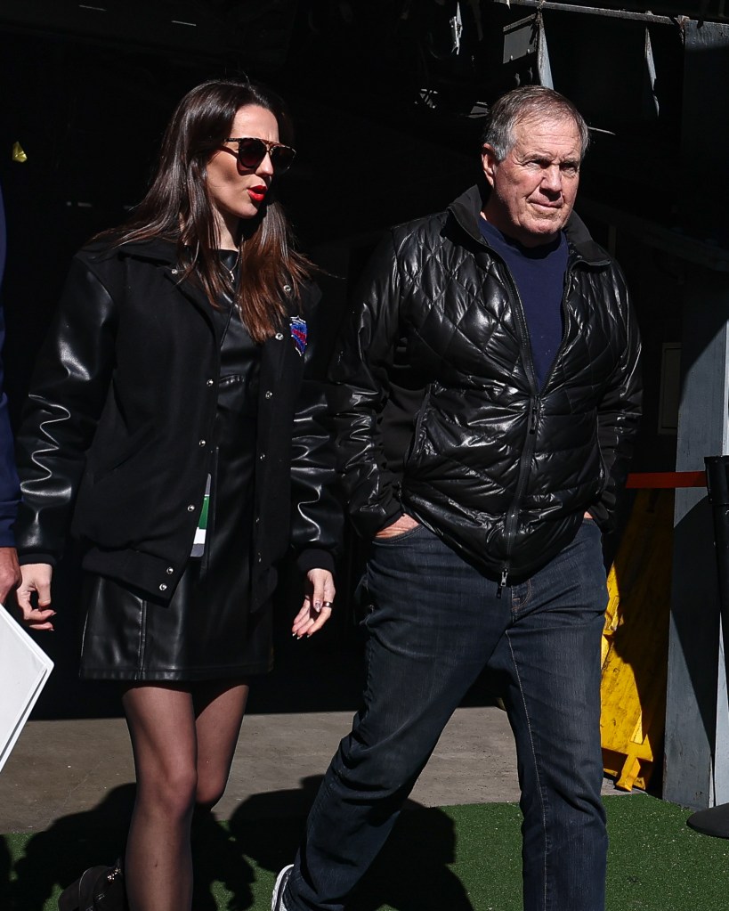 Former New England Patriots head coach Bill Belichick and girlfriend Jordon Hudson enter the field before the game between the Notre Dame Fighting Irish and the Navy Midshipmen at MetLife Stadium.