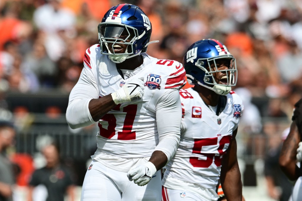 New York Giants linebackers Bobby Okereke (58) and Azeez Ojulari (51) celebrating after a sack during a football match against the Cleveland Browns