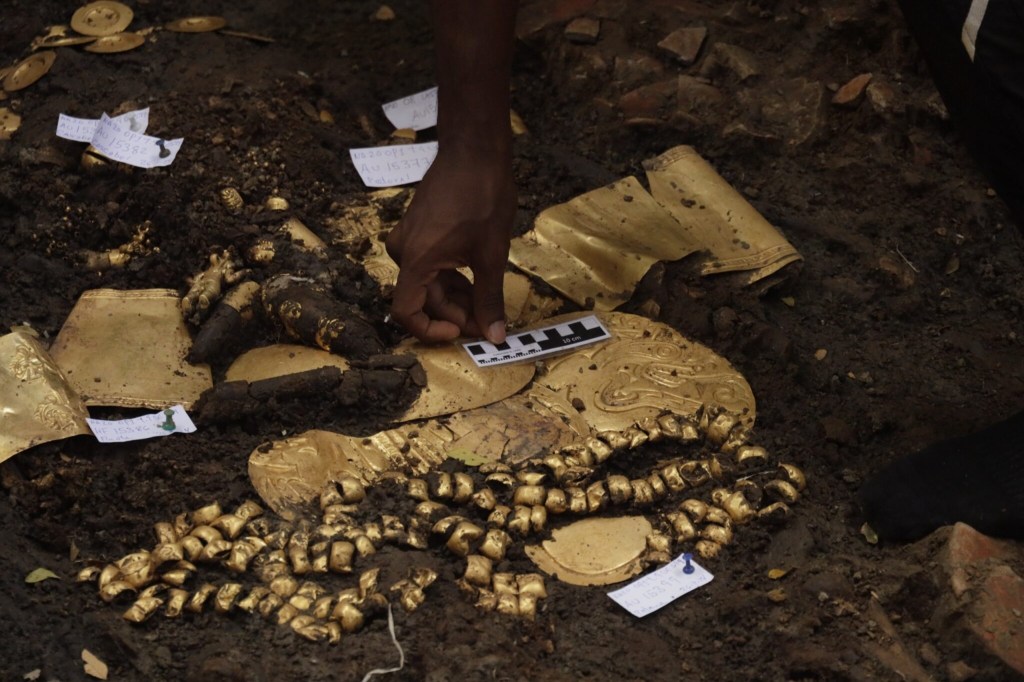 A golden object found in a 1,200-year-old tomb discovered by Panamanian archaeologists, along with victims of human sacrifice