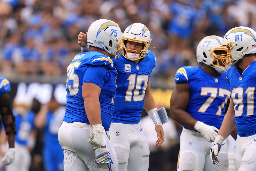 Chargers quarterback Justin Herbert (10) reacts after center Bradley Bozeman (75) was called for a personal foul.