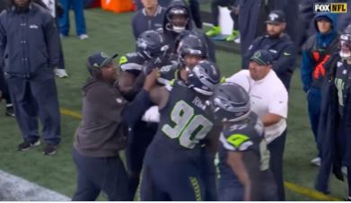 Seahawks defensive lineman Jarran Reed getting into it with linebacker Derick Hall on the sideline before being separated during Sunday's game. 