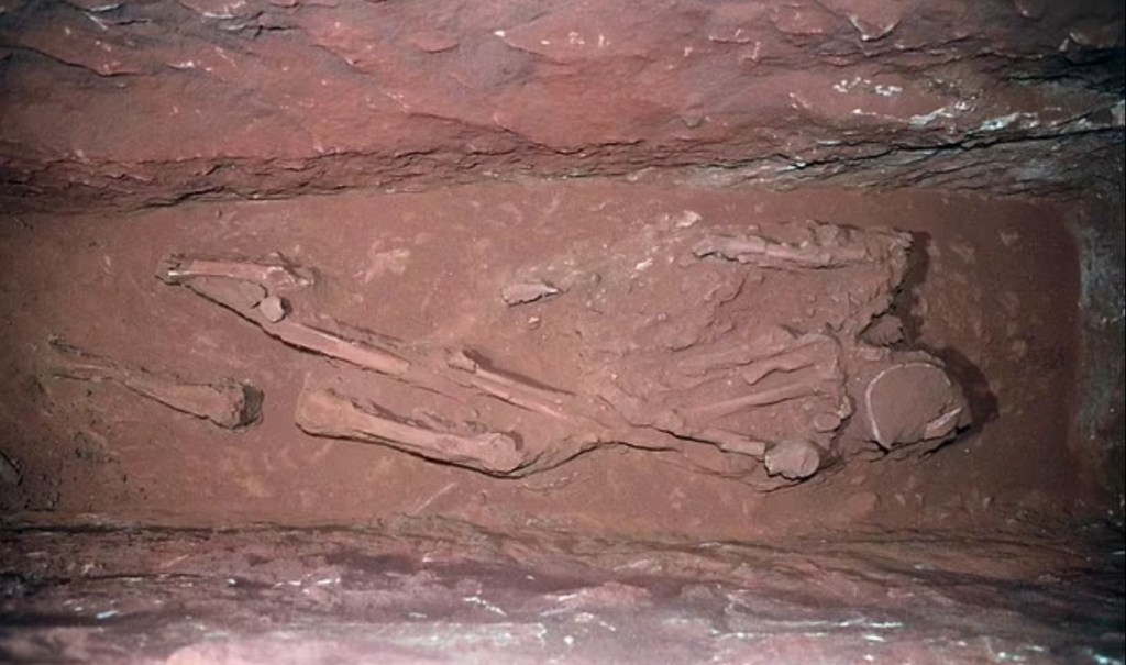 Archeology researchers uncovering a hidden tomb with 12 well-preserved skeletons beneath the treasury building at Nabatean ruins in Petra, Jordan