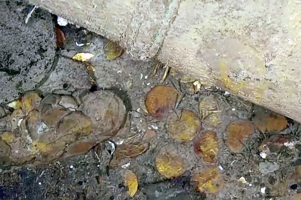 Treasure-laden galleon at the center of disputes with coins scattered on the ground