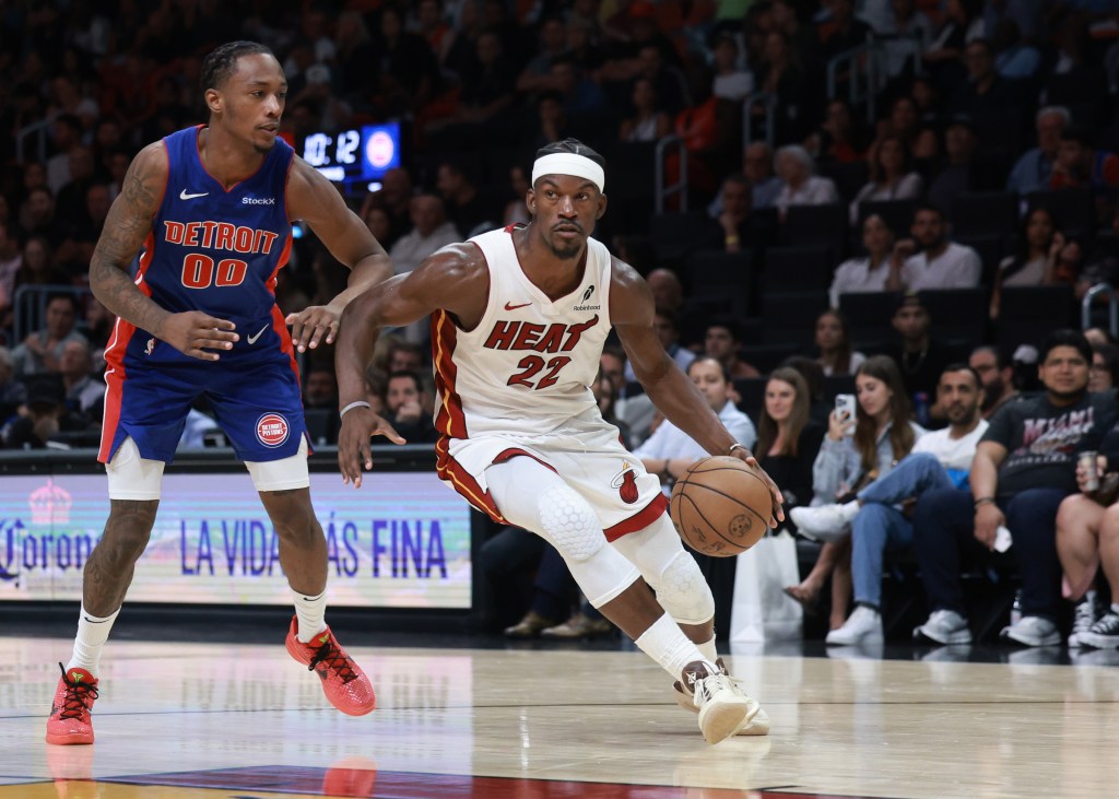 Jimmy Butler #22 of the Miami Heat controls the ball around Ronald Holland II #00 of the Detroit Pistons