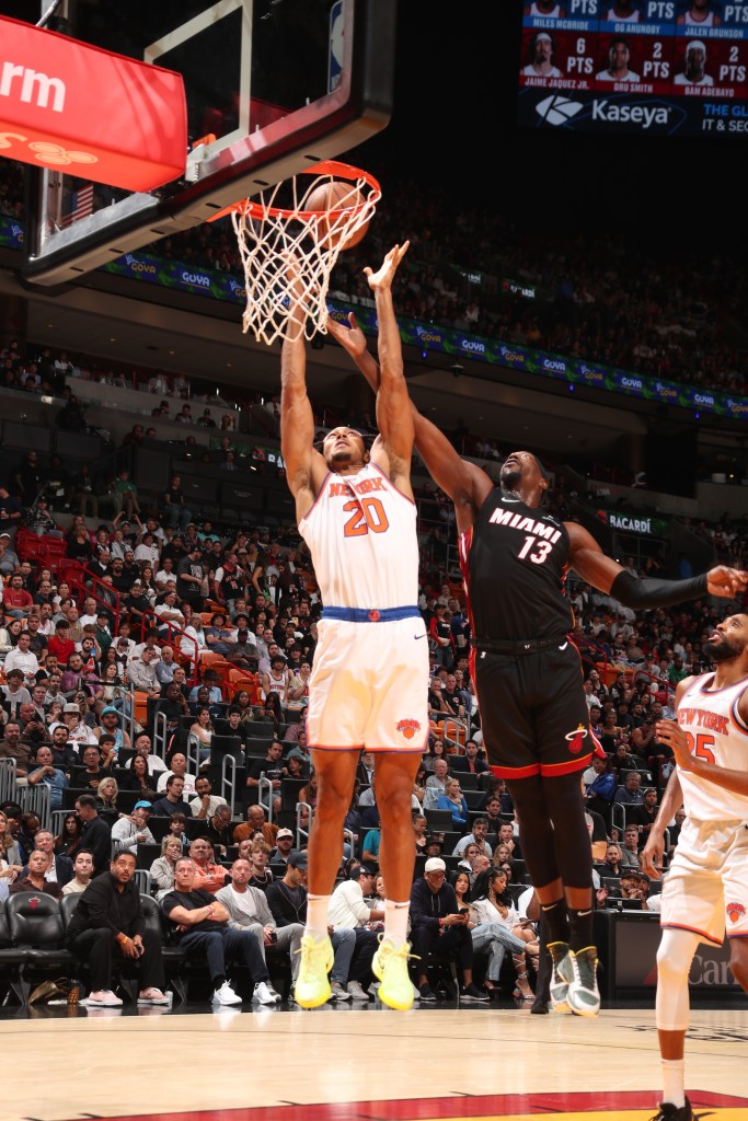 Jericho Sims #20 of the New York Knicks goes up for the rebound during the game against the Miami Heat on October 30, 2024 at Kaseya Center in Miami, Florida