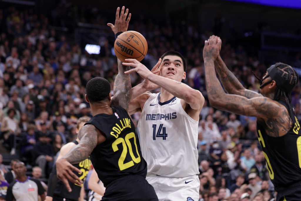 Utah Jazz forward John Collins fouling Memphis Grizzlies center Zach Edey during a basketball game on Oct 23, 2024