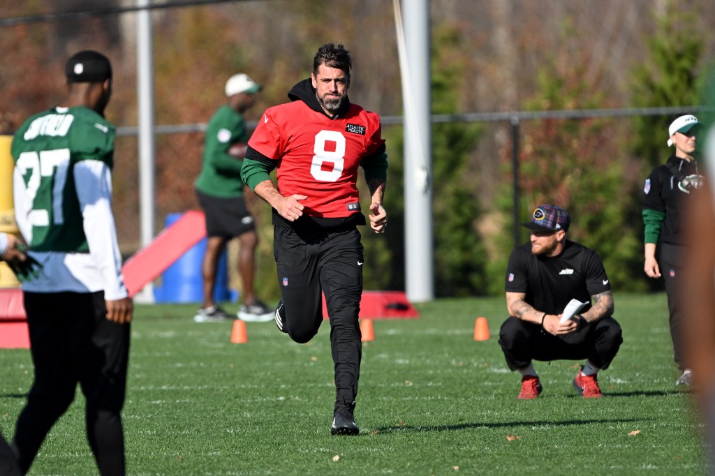 Jets quarterback Aaron Rodgers (8) runs during practice in Florham Park, NJ.  