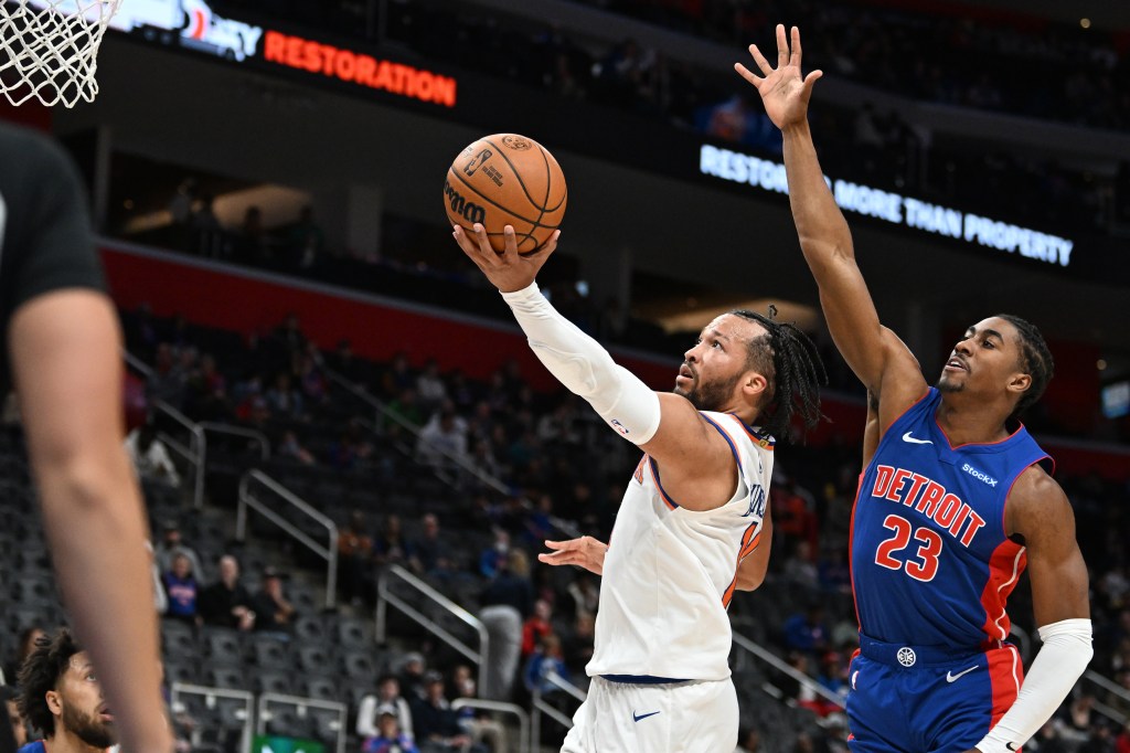  New York Knicks guard Jalen Brunson (11) drives past Detroit Pistons guard Jaden Ivey (23) for a layup in the third quarter at Little Caesars Arena. 