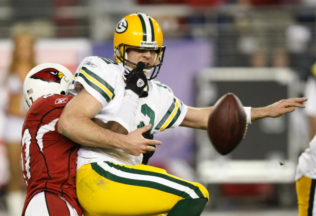 Arizona Cardinals' Michael Adams (27) hits Green Bay Packers' Aaron Rodgers and causes a fumble during the overtime of an NFL wild-card playoff football game Sunday, Jan. 10, 2010, in Glendale, Ariz.