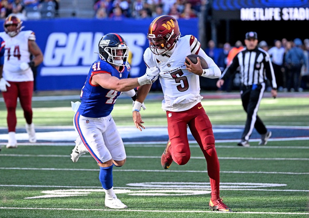 Jayden Daniels runs with the ball during the Commanders' win over the Giants on Nov. 3, 2024. 