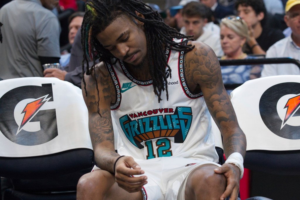 Memphis Grizzlies guard Ja Morant (12) sits on the bench after leaving the game with an injury in the second half of an NBA basketball game against the Los Angeles Lakers Wednesday, Nov. 6, 2024, in Memphis, Tenn.