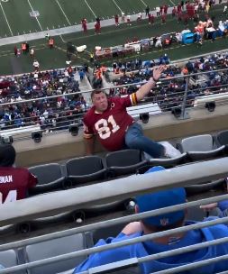 A Commanders fan falls down the seats at MetLife Stadium on Sunday.