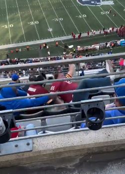 A Commanders fan falls down the seats at MetLife Stadium on Sunday.