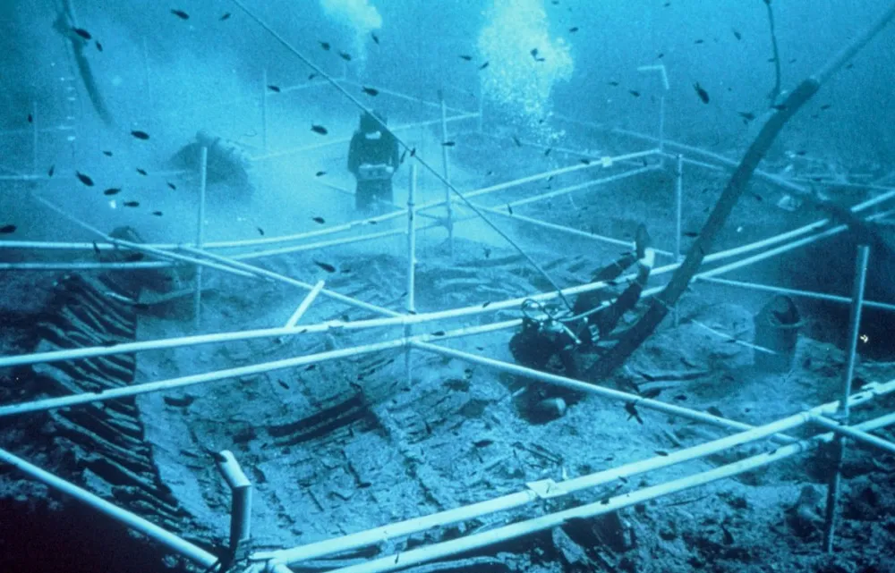 Underwater image of divers exploring a shipwreck