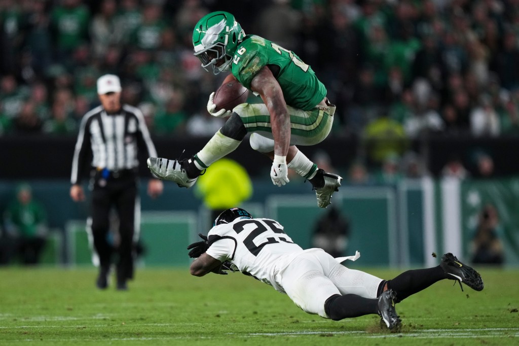 Eagles running back Saquon Barkley (26) leaps over Jacksonville Jaguars cornerback Ronald Darby (25) during the second half.