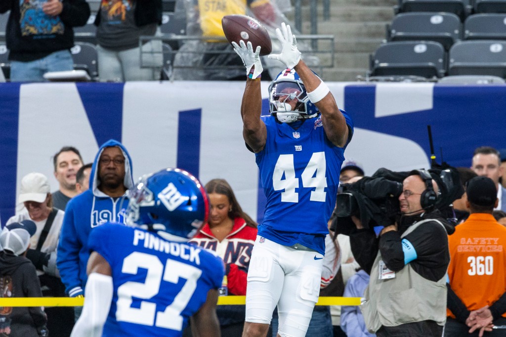 New York Giants cornerback Nick McCloud catching a football during pregame warm-ups at MetLife Stadium