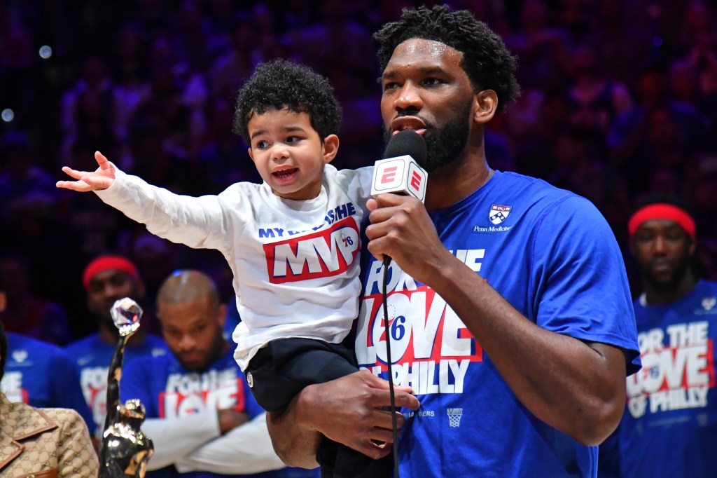 Joel Embiid holding his son, Arthur.