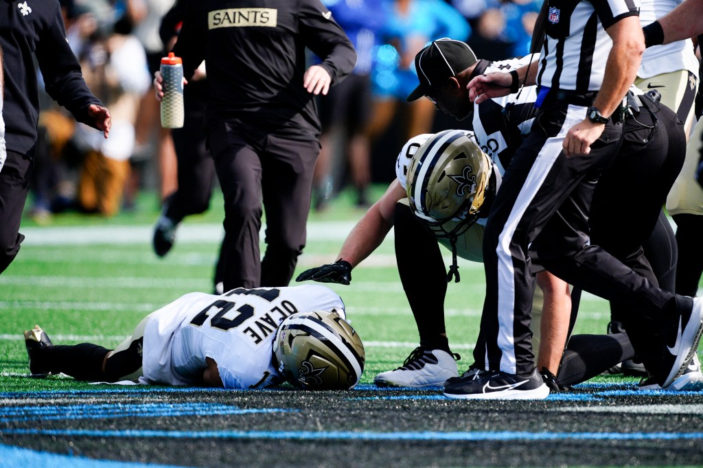 Saints receiver Chris Olave (12) down on the field after taking a big hit on Nov. 3, 2024.