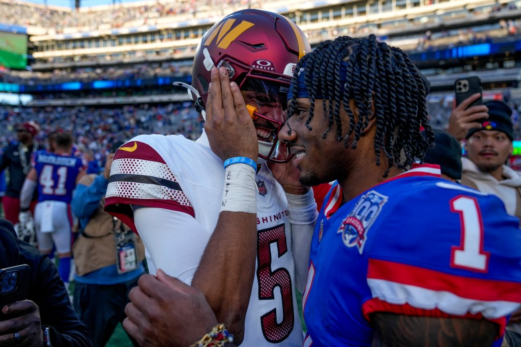 Malik Nabers (R.) and Jayden Daniels embrace after the Giants' loss to the Commanders on Nov. 3, 2024. 